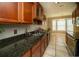 Eat-in kitchen featuring a bay window, tile floor, and stainless steel sink at 1507 Paces Ferry North Se, Smyrna, GA 30080