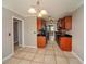 Galley kitchen with wooden cabinetry, black countertops, and tile flooring at 1507 Paces Ferry North Se, Smyrna, GA 30080