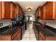 Galley kitchen featuring stainless steel appliances, granite counters, and wood cabinets at 1507 Paces Ferry North Se, Smyrna, GA 30080