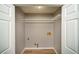 Laundry closet with new flooring, utility hookups, and shelving at 1507 Paces Ferry North Se, Smyrna, GA 30080