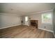 Bright living room with modern flooring, a fireplace, and an access door to the backyard at 1507 Paces Ferry North Se, Smyrna, GA 30080