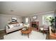 Cozy living room with neutral walls, a decorative fireplace, and a large picture window at 1507 Paces Ferry North Se, Smyrna, GA 30080
