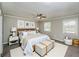 Staged primary bedroom featuring neutral walls, carpet, and ceiling fan at 1507 Paces Ferry North Se, Smyrna, GA 30080