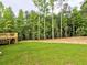 Green, well-manicured lawn in the backyard, and wooden deck at 3730 Reserve Overlook (Lot 8) Way, Cumming, GA 30041