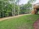 View of the backyard and deck that is bordered by mature hardwood trees at 3730 Reserve Overlook (Lot 8) Way, Cumming, GA 30041