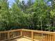 The wood deck overlooks the backyard featuring mature trees and serene natural beauty at 3730 Reserve Overlook (Lot 8) Way, Cumming, GA 30041