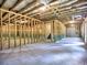 Large unfinished basement area framed with wood, showing access to stairs and utilities at 3730 Reserve Overlook (Lot 8) Way, Cumming, GA 30041