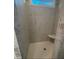 Beautiful walk-in shower featuring gray tile walls and a bench seat at 3730 Reserve Overlook (Lot 8) Way, Cumming, GA 30041
