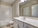 Bright, well-lit bathroom featuring a tub-shower combination, neutral tiling, and a vanity with ample counter space at 3730 Reserve Overlook (Lot 8) Way, Cumming, GA 30041