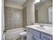 Bathroom with a tub and a shower combination, vanity with sink, and ample lighting at 3730 Reserve Overlook (Lot 8) Way, Cumming, GA 30041