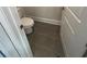 Tiled half bathroom with a toilet and small sink at 3730 Reserve Overlook (Lot 8) Way, Cumming, GA 30041