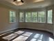 Sun-filled main bedroom features dark hardwood floors and multiple windows overlooking mature trees at 3730 Reserve Overlook (Lot 8) Way, Cumming, GA 30041