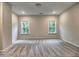 Bright bedroom features neutral walls, plush carpet, and natural light from two windows with treed view at 3730 Reserve Overlook (Lot 8) Way, Cumming, GA 30041