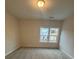 Carpeted bedroom featuring a large window and neutral walls at 3730 Reserve Overlook (Lot 8) Way, Cumming, GA 30041