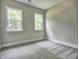 An empty bedroom with neutral walls and plush gray carpet awaits personal touches at 3730 Reserve Overlook (Lot 8) Way, Cumming, GA 30041