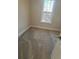 Carpeted bedroom features a large window and neutral walls at 3730 Reserve Overlook (Lot 8) Way, Cumming, GA 30041