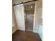 Bedroom with wood flooring, a sliding barn door, and neutral walls at 3730 Reserve Overlook (Lot 8) Way, Cumming, GA 30041