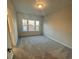 Carpeted bedroom with a large window and neutral paint at 3730 Reserve Overlook (Lot 8) Way, Cumming, GA 30041