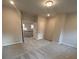 Finished bonus room with plush carpet and a view into the foyer at 3730 Reserve Overlook (Lot 8) Way, Cumming, GA 30041