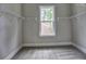 Walk-in closet with carpeted floor, window, and metal shelving for storage at 3730 Reserve Overlook (Lot 8) Way, Cumming, GA 30041