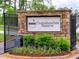Stone entrance sign to Chattahoochee Reserve with landscaped flower bed and wrought iron gate at 3730 Reserve Overlook (Lot 8) Way, Cumming, GA 30041