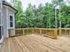 Spacious wooden deck overlooking a lush, green backyard surrounded by mature trees at 3730 Reserve Overlook (Lot 8) Way, Cumming, GA 30041