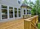 View of the deck with wood railing and large windows on the exterior of the home at 3730 Reserve Overlook (Lot 8) Way, Cumming, GA 30041