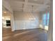 Elegant dining room with coffered ceilings, wainscoting, hardwood floors, and a modern chandelier at 3730 Reserve Overlook (Lot 8) Way, Cumming, GA 30041