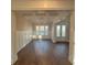Elegant dining room with coffered ceilings, wainscoting, hardwood floors, and a modern chandelier at 3730 Reserve Overlook (Lot 8) Way, Cumming, GA 30041