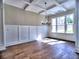 Dining room with coffered ceiling, dark wood floors, wainscotting and large windows providing natural light at 3730 Reserve Overlook (Lot 8) Way, Cumming, GA 30041
