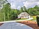 Scenic driveway leading to a beautiful home, showcasing the property's curb appeal and lush surroundings at 3730 Reserve Overlook (Lot 8) Way, Cumming, GA 30041