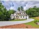 Charming home nestled among trees, highlighting the property's curb appeal and tranquil environment at 3730 Reserve Overlook (Lot 8) Way, Cumming, GA 30041