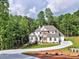 Beautiful home with lush surroundings, showcasing the property's curb appeal and manicured landscaping at 3730 Reserve Overlook (Lot 8) Way, Cumming, GA 30041