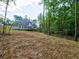 Back exterior of the home with a wooden deck overlooking the landscaped yard at 3730 Reserve Overlook (Lot 8) Way, Cumming, GA 30041