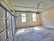 Spacious two car garage with concrete floor and windows to let in natural light at 3730 Reserve Overlook (Lot 8) Way, Cumming, GA 30041