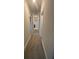 Bright hallway with neutral-toned walls, carpeted flooring, and multiple doorways, offering a smooth transition between rooms at 3730 Reserve Overlook (Lot 8) Way, Cumming, GA 30041