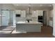 Modern kitchen featuring white cabinets, stainless steel appliances, and a center island with pendant lighting at 3730 Reserve Overlook (Lot 8) Way, Cumming, GA 30041