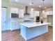 Bright kitchen features modern cabinetry, stainless steel appliances, stylish pendant lighting, and a spacious center island at 3730 Reserve Overlook (Lot 8) Way, Cumming, GA 30041