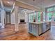 Open concept kitchen with island, stainless sink, pendant lighting, and view of the fireplace at 3730 Reserve Overlook (Lot 8) Way, Cumming, GA 30041
