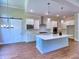 Kitchen with island, stainless appliances, quartz counters, pendant lights, and custom cabinets at 3730 Reserve Overlook (Lot 8) Way, Cumming, GA 30041