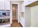 A well-equipped kitchen with stainless steel appliances, white cabinets, and tiled backsplash at 3730 Reserve Overlook (Lot 8) Way, Cumming, GA 30041