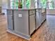 Kitchen island with light grey cabinets, stainless steel appliances, and hardwood floors at 3730 Reserve Overlook (Lot 8) Way, Cumming, GA 30041