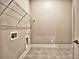 Laundry room with tile floor, wire rack shelving and hook ups for the washer and dryer at 3730 Reserve Overlook (Lot 8) Way, Cumming, GA 30041