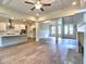 Open concept living room with fireplace, kitchen island, stainless vent hood, and lots of natural light at 3730 Reserve Overlook (Lot 8) Way, Cumming, GA 30041
