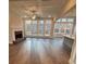Bright and airy living room featuring a fireplace, hardwood floors, large windows, and a walk-out deck at 3730 Reserve Overlook (Lot 8) Way, Cumming, GA 30041