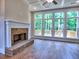 Bright living room features brick fireplace and large windows with a view of the deck at 3730 Reserve Overlook (Lot 8) Way, Cumming, GA 30041