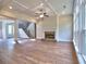 Bright living room with fireplace, hardwood floors, and a view of the stairway at 3730 Reserve Overlook (Lot 8) Way, Cumming, GA 30041