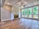 Spacious living room features hardwood floors, coffered ceilings, and a brick fireplace next to wall of windows at 3730 Reserve Overlook (Lot 8) Way, Cumming, GA 30041