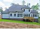 A home's rear exterior featuring a deck, a large backyard and multiple windows providing ample natural light at 3730 Reserve Overlook (Lot 8) Way, Cumming, GA 30041