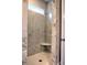 Tiled walk-in shower with marble-like tile, small shelf, and neutral-colored grout at 3730 Reserve Overlook (Lot 8) Way, Cumming, GA 30041
